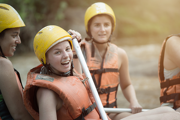 People carring inflatable raft
