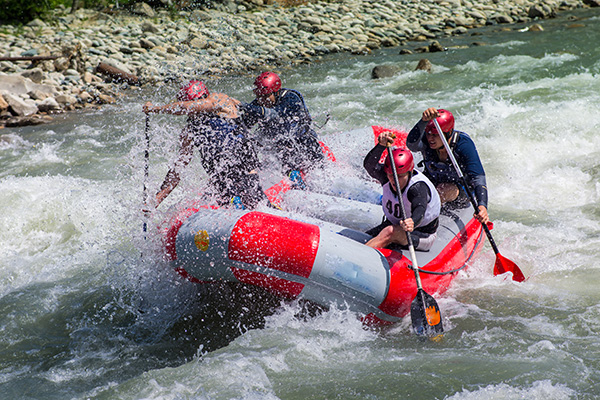 People carring inflatable raft